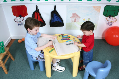 two kids doing coloring